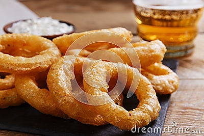 Fried onion rings in batter with sauce Stock Photo