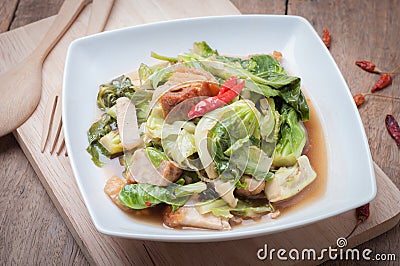 Fried Oyster sauce vegetables sect with crispy pork on wood floors. Stock Photo