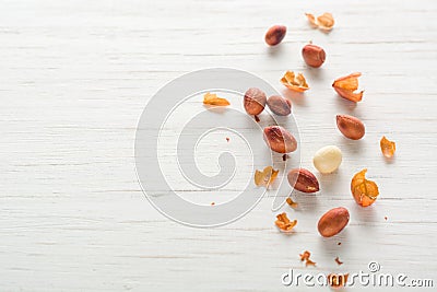 Fried peanut on a white wooden background. Stock Photo