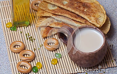 Fried pies, cheese, sunflower oil, milk and bagels on a plate cl Stock Photo