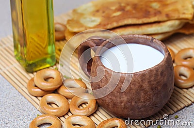 Fried pies, cheese, sunflower oil, milk and bagels on a plate cl Stock Photo