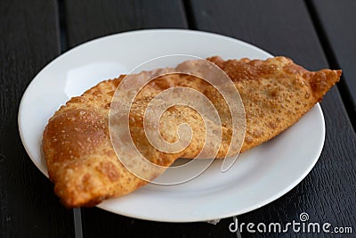 fried pies with meat - chebureks oriental cuisine Stock Photo