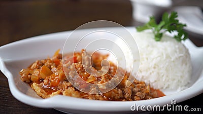 Fried pork with tomato sauce. Eggs bomb,cooking Thai Food. Stock Photo