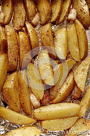 Fried potatoes in foil from oven Stock Photo