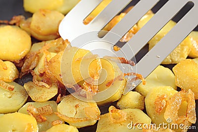 Fried potatoes' slices Stock Photo