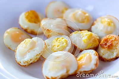 Fried quail eggs for breakfast on white dish Stock Photo