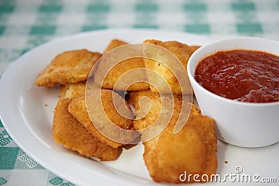 Fried ravioli on white plate with marinara sauce Stock Photo