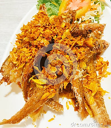 Fried river fish with garlic and pepper Stock Photo