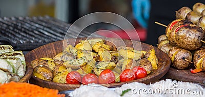 Fried and roast potato and tomatos on plate Stock Photo