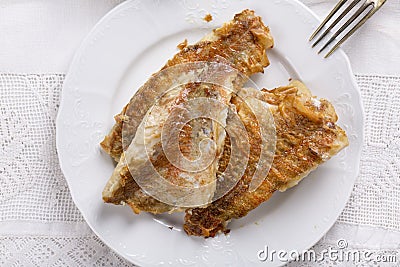 Fried rose fish fillet on a white plate Stock Photo