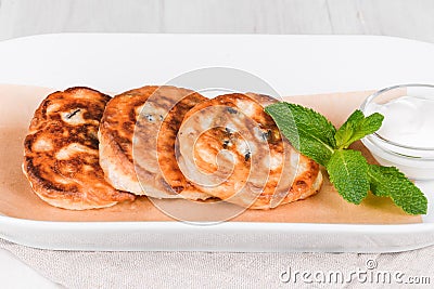 Fried Russian curd fritter pancakes on a plate Stock Photo