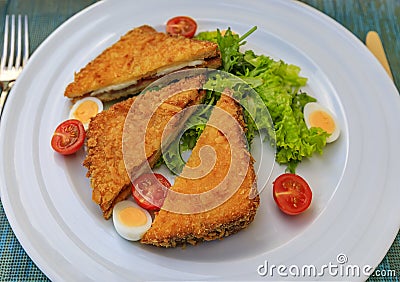 Montenegrin fried sandwich, fritter, with goat cheese and Njeguski prsut meat with tomatoes, boiled quail egg and salad Stock Photo