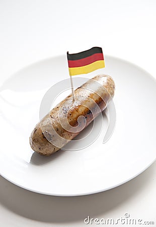 Fried sausage in plate with German flag decoration against white background Stock Photo