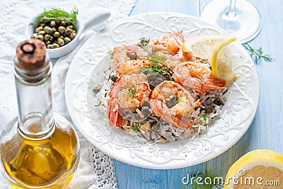 Fried shrimp with capers, herbs and wild rice Stock Photo