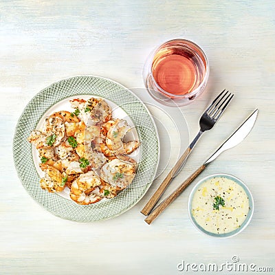 Fried shrimps with a glass of rose wine and a dip Stock Photo