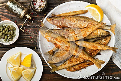 Fried smelt in a white plate. Small fish Stock Photo