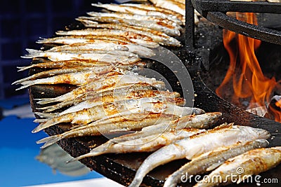 Fried smelts on barbecue fire bowl Stock Photo