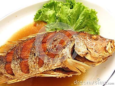 Fried snapper with fish sauce on the dish Stock Photo