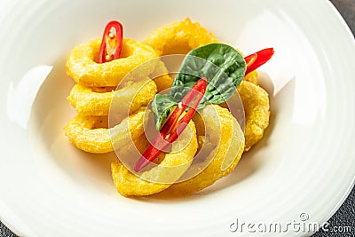 fried squids or octopus calamari with sauce. Food recipe background. Close up Stock Photo