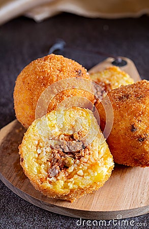 Fried stuffed Sicilian arancini with breadcrumbs Stock Photo