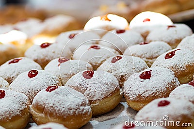 Fried and stuffed sufganiot with strawberry jam, Stock Photo