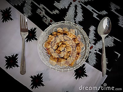 Photo of fried tempeh in a glass bowl placed on a black table Stock Photo