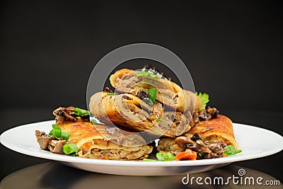 fried thin pancakes stuffed with meat and mushrooms. Stock Photo