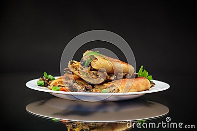 fried thin pancakes stuffed with meat and mushrooms. Stock Photo