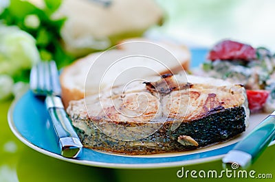 Fried tuna with a knife and fork on the dish Stock Photo