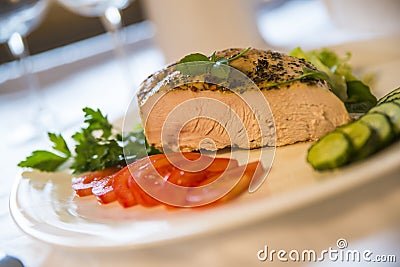 Fried turkey meat with tomatoes and cucumbers on the plate Stock Photo