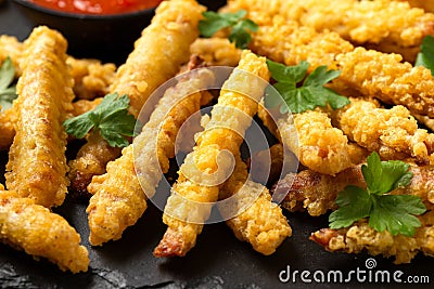 Fried Vegan jackfruit and oyster prawns in crispy batter served on black slate with chili dip sauce Stock Photo