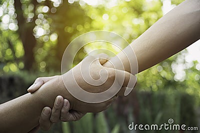 Friend holding hands together at outdoor. Hand holding between colleagues. Friendship and teamwork concept Stock Photo