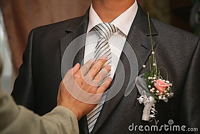 Friend straightens his tie groom Stock Photo