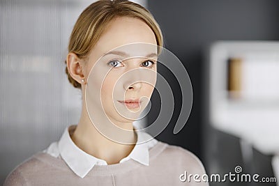 Friendly adult casual dressed business woman or student girl standing straight. Business headshot or portrait in office Stock Photo