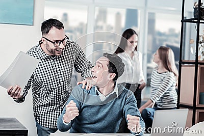 Friendly amazed colleagues rejoicing and having fun. Stock Photo