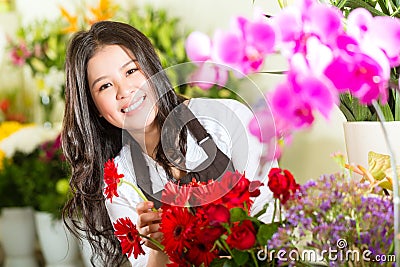 Chinese Saleswoman in a flower shop Stock Photo