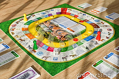 A friendly board game spread out on a table in the room. Gameplay in progress Editorial Stock Photo