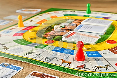 A friendly board game spread out on a table in the room. Gameplay in progress Editorial Stock Photo