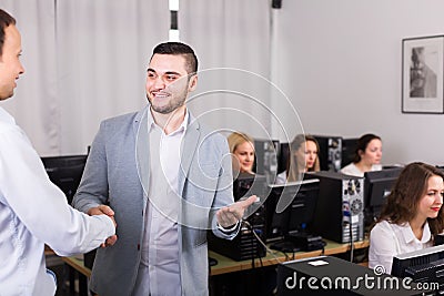 Friendly boss greeting new colleague Stock Photo