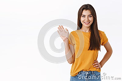 Friendly cheerful, happy smiling woman waving you with raised hand. Attractive girl greeting friend, say hello or hi Stock Photo