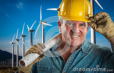 Friendly Contractor in Hard Hat Holding Extension Cord By Turbines Stock Photo
