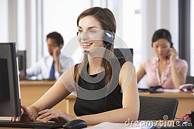 Friendly Customer Service Agent In Call Centre Stock Photo