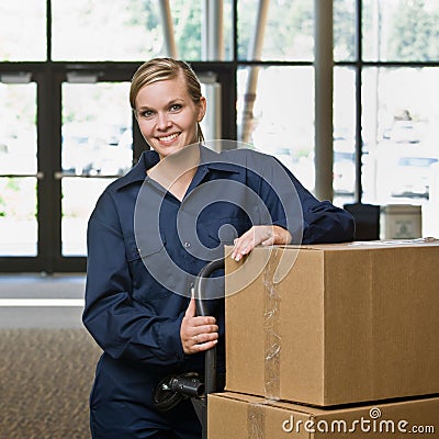 Friendly delivery woman in uniform Stock Photo