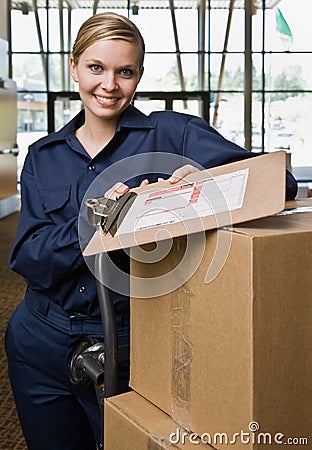 Friendly delivery woman in uniform Stock Photo