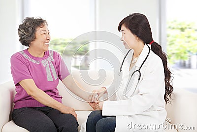 Friendly doctor caring senior woman indoor room Stock Photo