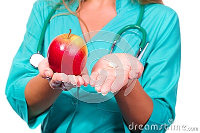 Friendly doctor with pill and apple Stock Photo