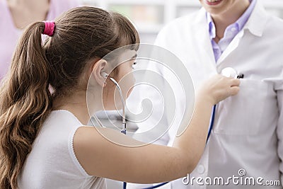 Friendly doctor playing with a young patient during a visit Stock Photo