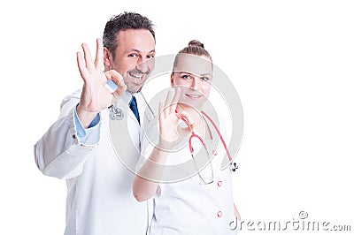 Friendly doctors acting confident and showing ok hand sign Stock Photo