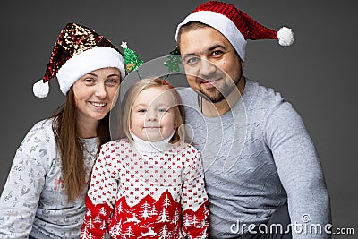 Friendly family of three standing together and smiling Stock Photo