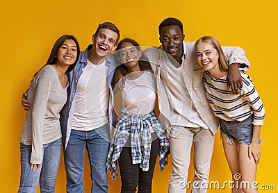 Friendly group of international students smiling over yellow background Stock Photo